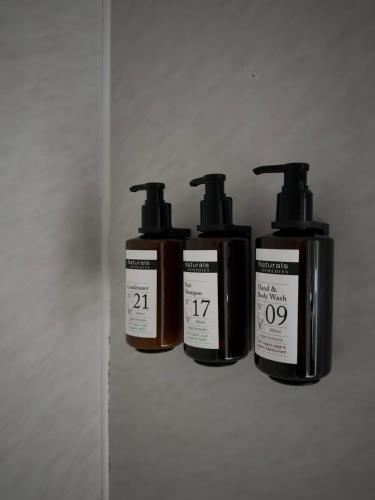 four bottles of soap sitting on a wall at Calder Family Motel in Bendigo