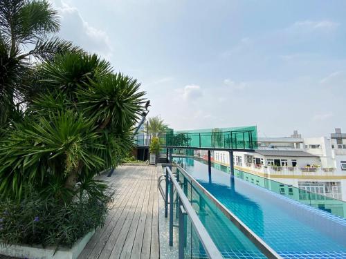 a balcony with a swimming pool on a building at CHECK inn Phnom Penh Royal Palace in Phnom Penh