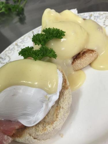 a sandwich with meat and cheese on a plate at The Mowbray in Eastbourne