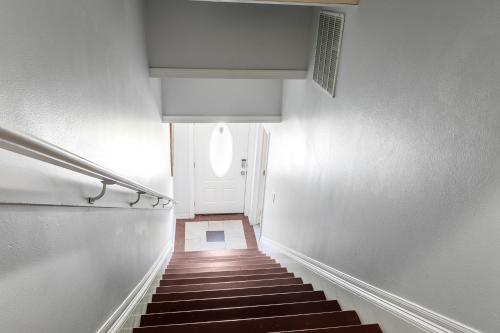 a hallway with stairs leading to a white door at Modern 4BR Elegant Living - Downtown NOLA in New Orleans