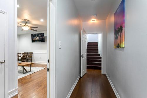 a hallway with a staircase in a home with white walls at Modern 4BR Elegant Living - Downtown NOLA in New Orleans