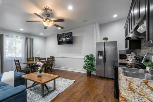 a kitchen and living room with a couch and a table at Modern 4BR Elegant Living - Downtown NOLA in New Orleans