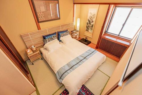 a bedroom with a large bed and a window at Hotel Ginnan in Tokyo