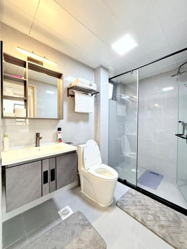 a bathroom with a toilet and a sink and a shower at Pearl Luxe Homes at Orchid Residency - Spacious 2BR in Westlands With Pool, Gym, Rooftop views & breakfast café in Nairobi