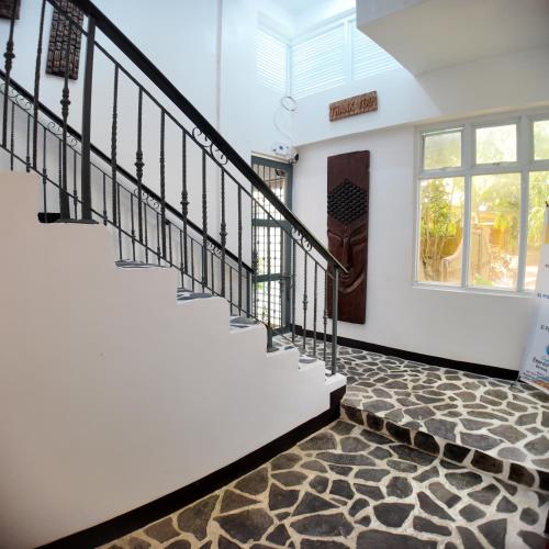 a staircase in a house with a stone floor at El Puerto Boracay in Boracay