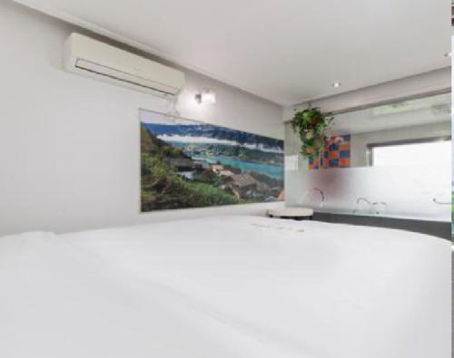 a bathroom with a sink and a painting on the wall at Star Spa Hotel in Haenam
