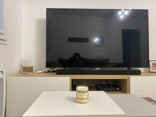 a living room with a large flat screen tv at Appartement plein centre à 50m de la plage in Soulac-sur-Mer