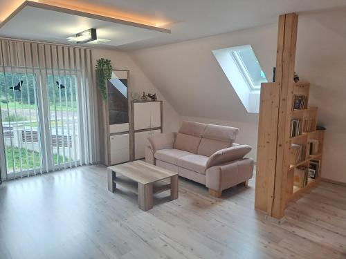 a living room with a couch and a table at H apartment in Jankov