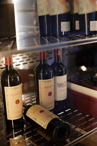 three bottles of wine sitting on a shelf at Hotel Villa La Bollina in Serravalle Scrivia