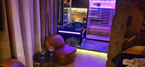 a living room with a chair and a window at Apartament Przy Murach in Toruń