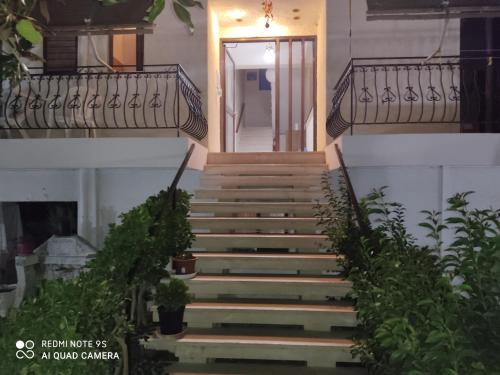 a stairway leading up to a building with a door at Rousetis in Aígio