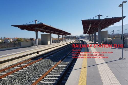 a train station with a train on the tracks at Rousetis in Aígio