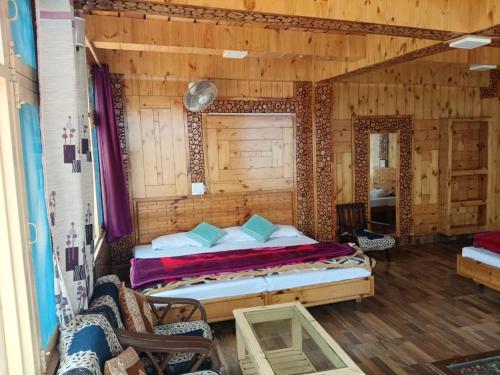 a bedroom with a bed in a wooden room at MRB Residency By StayApart in Chakrāta