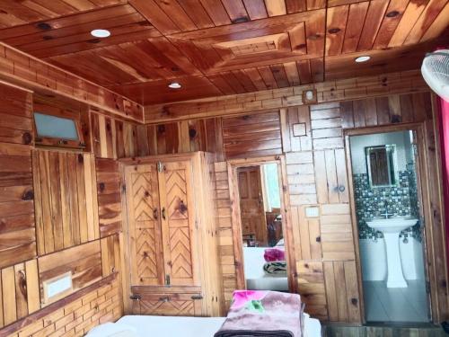 a room with wooden walls and wooden ceiling at MRB Residency By StayApart in Chakrāta