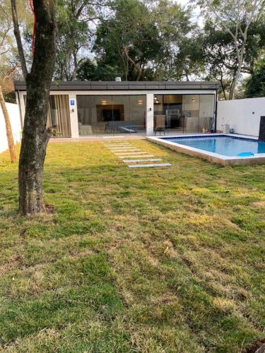 a house with a swimming pool in a yard at Alojamiento de Samber Nuevo y Moderno in San Bernardino