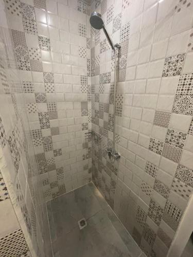 a bathroom with a shower with a glass door at SLEEP STUDIO Hostel in Yerevan
