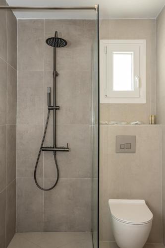 a bathroom with a shower with a toilet at Gloria Luxury Suites in Kallithea Halkidikis