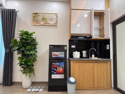 a small kitchen with a sink and a refrigerator at Baodang-Homestay in Hanoi