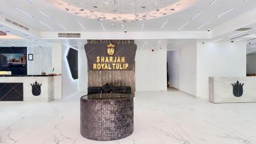 a room with a sign that reads sahm royal club at Royal Tulip Dancenter Suites Sharjah in Sharjah
