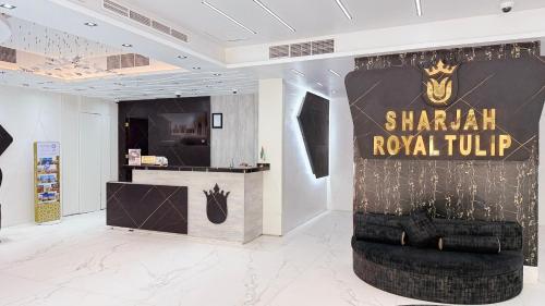 a store with a sign for shanghai royal tour at Royal Tulip Dancenter Suites Sharjah in Sharjah