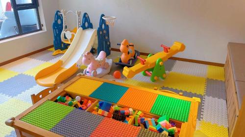 a childs play area with toys and a slide at Yunshan Villa in Huangshan Scenic Area