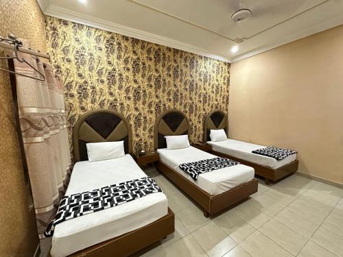 Postel nebo postele na pokoji v ubytování Hotel Grand Palace Multan