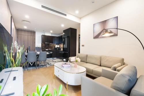 a living room with a couch and a table at Lumiere Riverside Heera Stay Apartment in Ho Chi Minh City