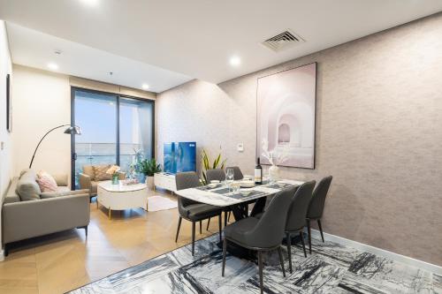 a dining room with a table and chairs at Lumiere Riverside Heera Stay Apartment in Ho Chi Minh City