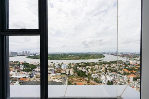 a view of a river from a window at Lumiere Riverside Heera Stay Apartment in Ho Chi Minh City