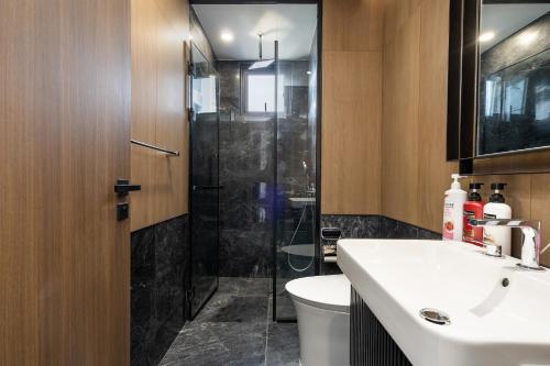a bathroom with a toilet and a sink and a shower at Lumiere Riverside Heera Stay Apartment in Ho Chi Minh City