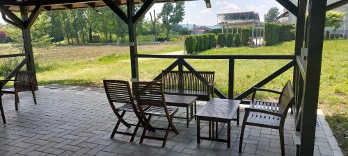 a group of chairs and tables on a patio at Vila El Barco in Veliko Gradište