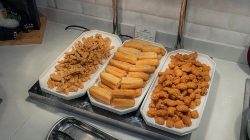 three trays of food on a counter next to a sink at Holiday Inn Express Chengdu Wuhou New City by IHG in Chengdu