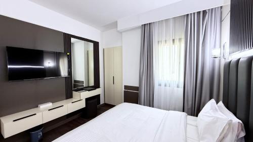 Letto o letti in una camera di Belvilla Royal Tulip Sharjah Aparthotel