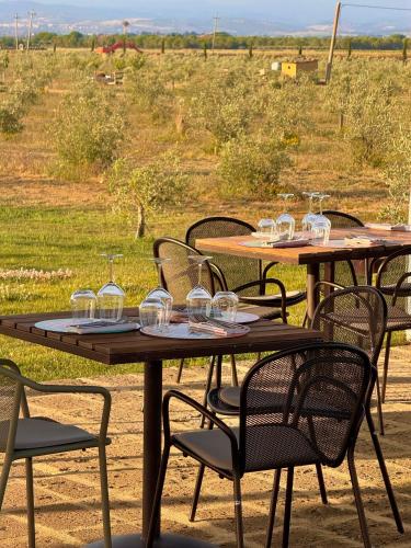 a group of tables with wine glasses on them at Casale Oliveta in Orbetello