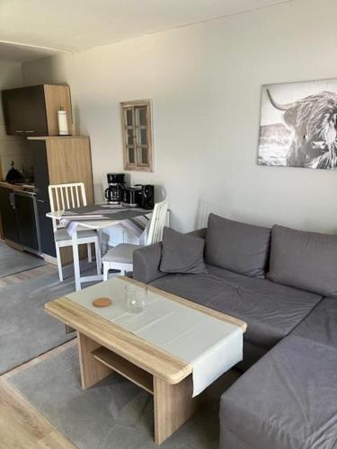 a living room with a couch and a table at von Wiegen, Ferienwohnungen in Schneverdingen