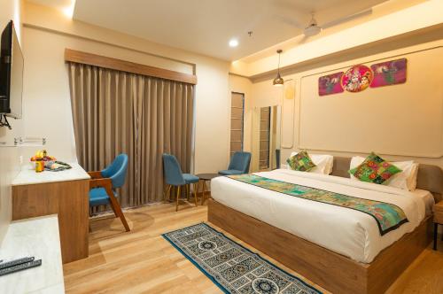 a hotel room with a bed and a desk at Hotel Lake Metro in Udaipur