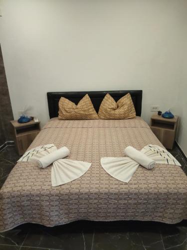 a large bed with two pillows on it at Villa Relax Apartment Nr 1 in Donji Štoj