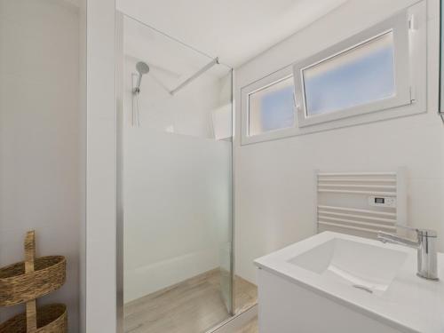 a white bathroom with a sink and a shower at Une grande maison pour 10 proche de la mer in Saint-Gilles-Croix-de-Vie