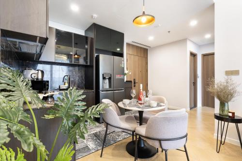 a kitchen and dining room with a table and chairs at Lumiere Riverside Heera Stay Apartment in Ho Chi Minh City