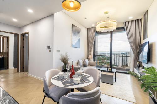 a living room with a table and chairs at Lumiere Riverside Heera Stay Apartment in Ho Chi Minh City