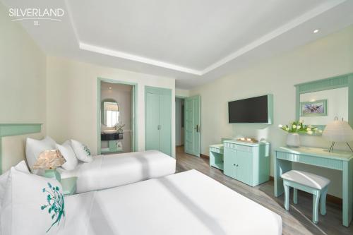 a hotel room with a bed and a desk at Silverland Sil Hotel in Ho Chi Minh City