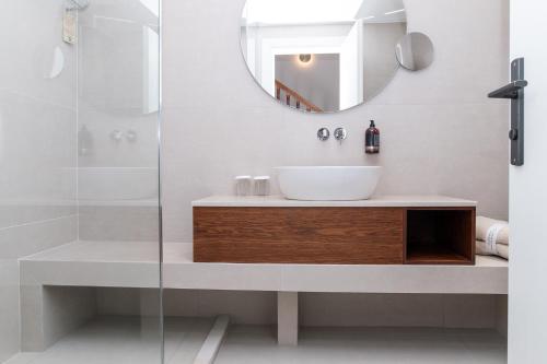 a bathroom with a sink and a mirror at Achilleas Beach Hotel Adults Only in Mastichari