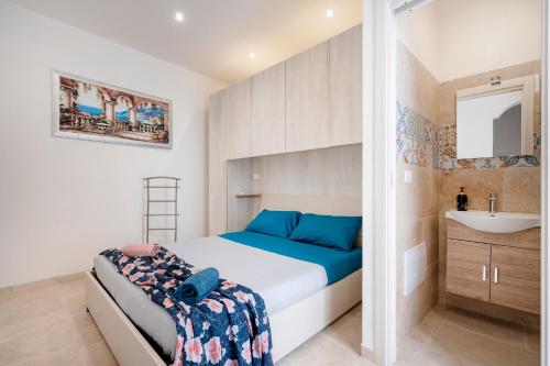 a small bedroom with a bed and a sink at Dimora Don Gabriele in Mola di Bari