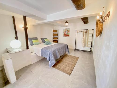 a bedroom with a bed and a tiled floor at Cabris Village - Elegant Family House in Cabris