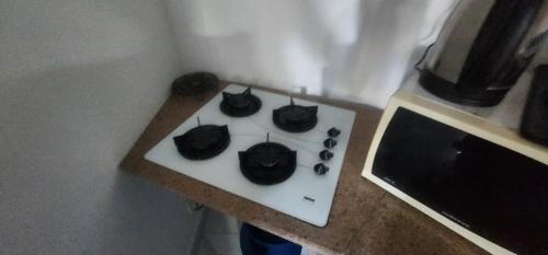 a stove with four black cats sitting on it at lucky villas in Trou aux Biches