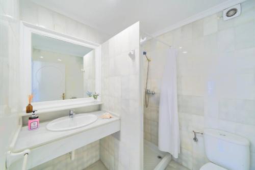 a white bathroom with a sink and a toilet at Riad Salt Pool Bliss Apartamentos in Torremolinos