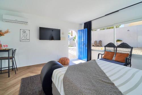 a bedroom with a bed and a flat screen tv at Riad Salt Pool Bliss Apartamentos in Torremolinos
