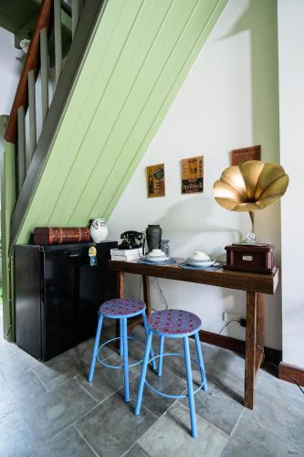 a kitchen with a wooden table and two stools at Baan Lek Tee 6 - 9Chinatown near Yaowarat and MRT in Bangkok