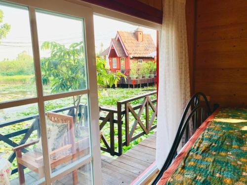 a room with a view of a house from a window at Khu nghỉ dưỡng Ba Hạt Dẻ in Sóc Sơn
