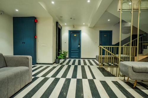 a lobby with blue doors and striped flooring at Hotel Lake Metro in Udaipur